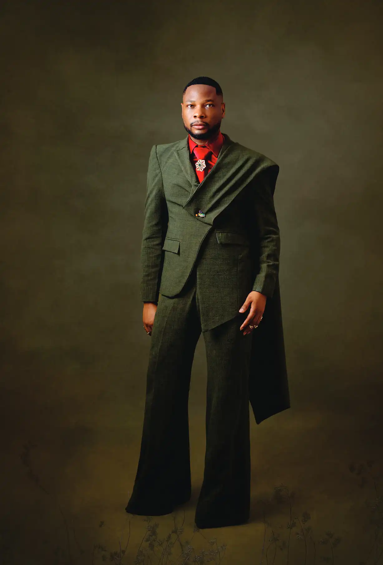 Chukwukadibia Ezeanyawu in a green tailored suit