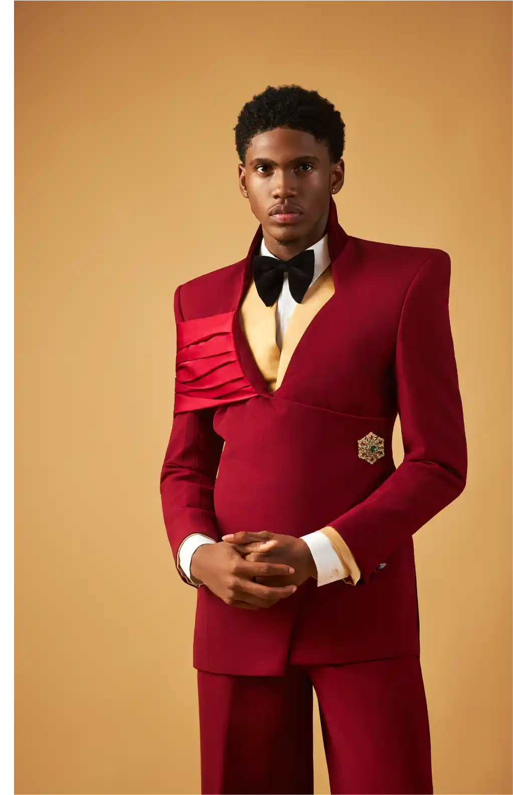 Man in red blazer standing on white pedestal