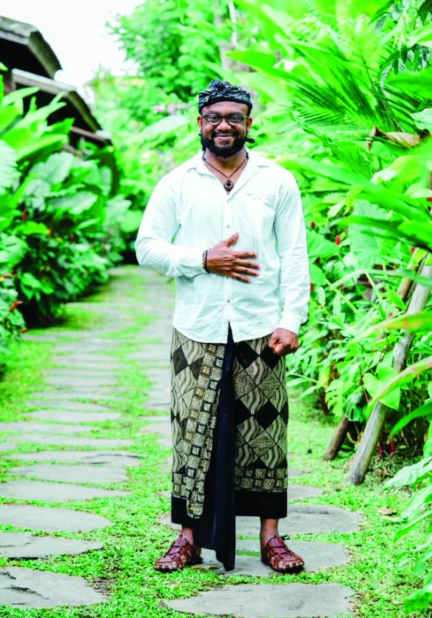 WakaWaka Doctor on a stone garden path in a wrapper and white shirt