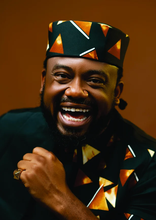 WakaWaka Doctor laughing in a patterned cap
